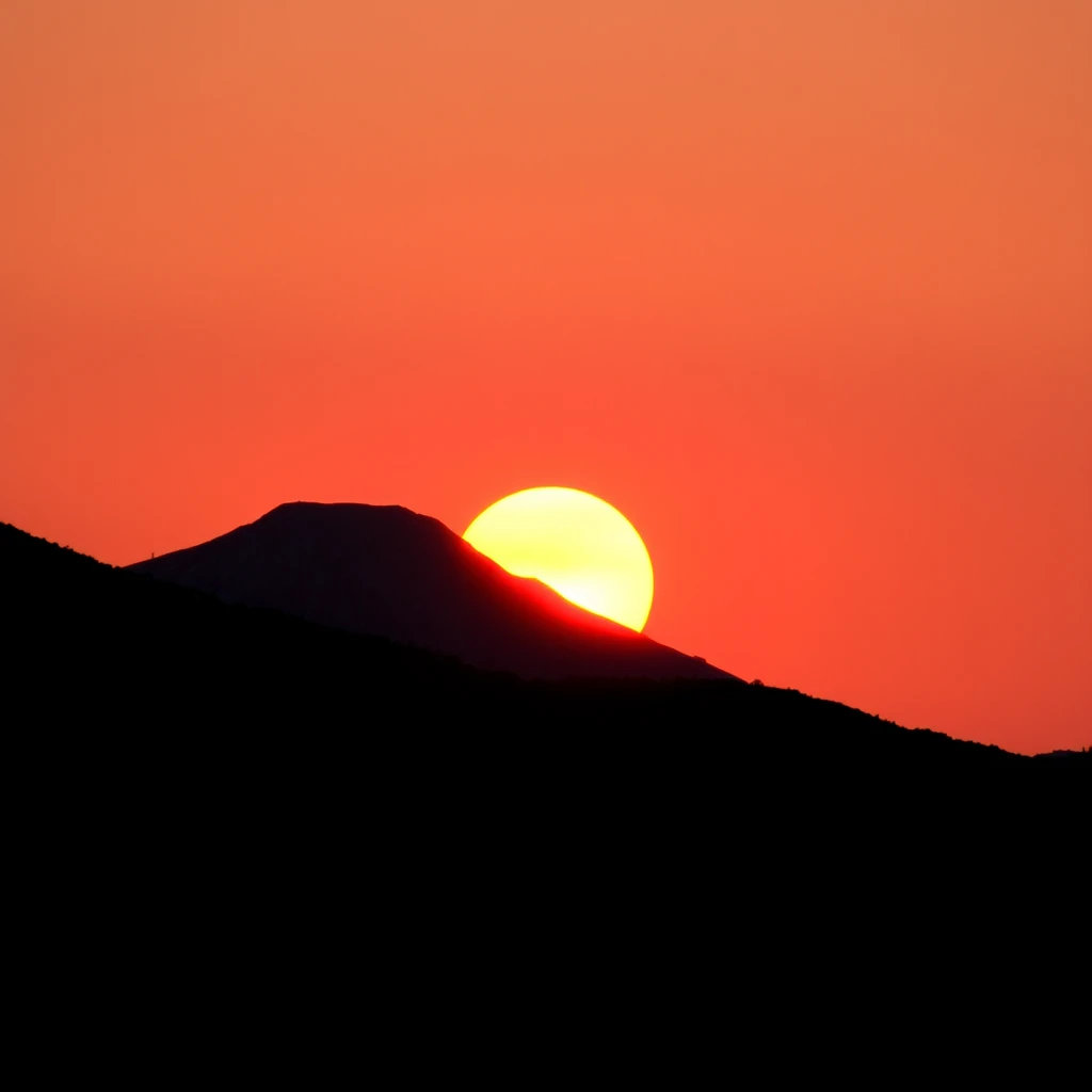 A sun back with a snow mountain at sunset.