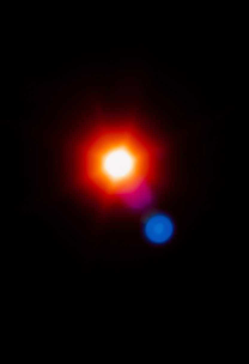 A bright orange and blue light is shown in a dark background.